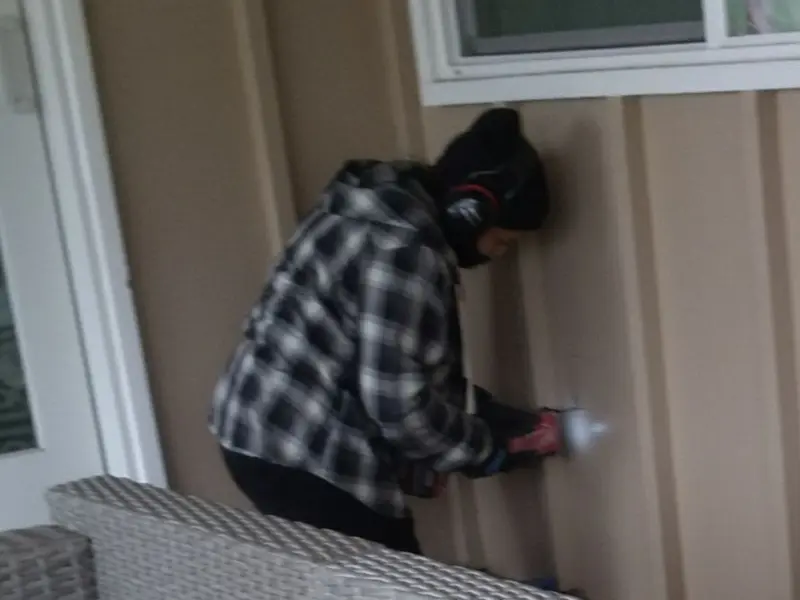 Professional electrician installing an exterior outlet in Milton